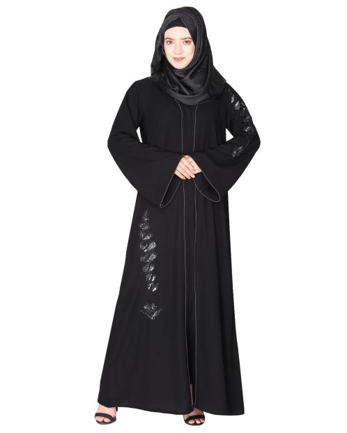 Opulent hand embroidered front open black abaya with a unique twisted motif of sparkling sequins