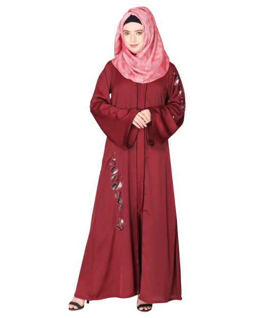 Opulent hand embroidered front open maroon abaya with a unique twisted motif of sparkling sequins